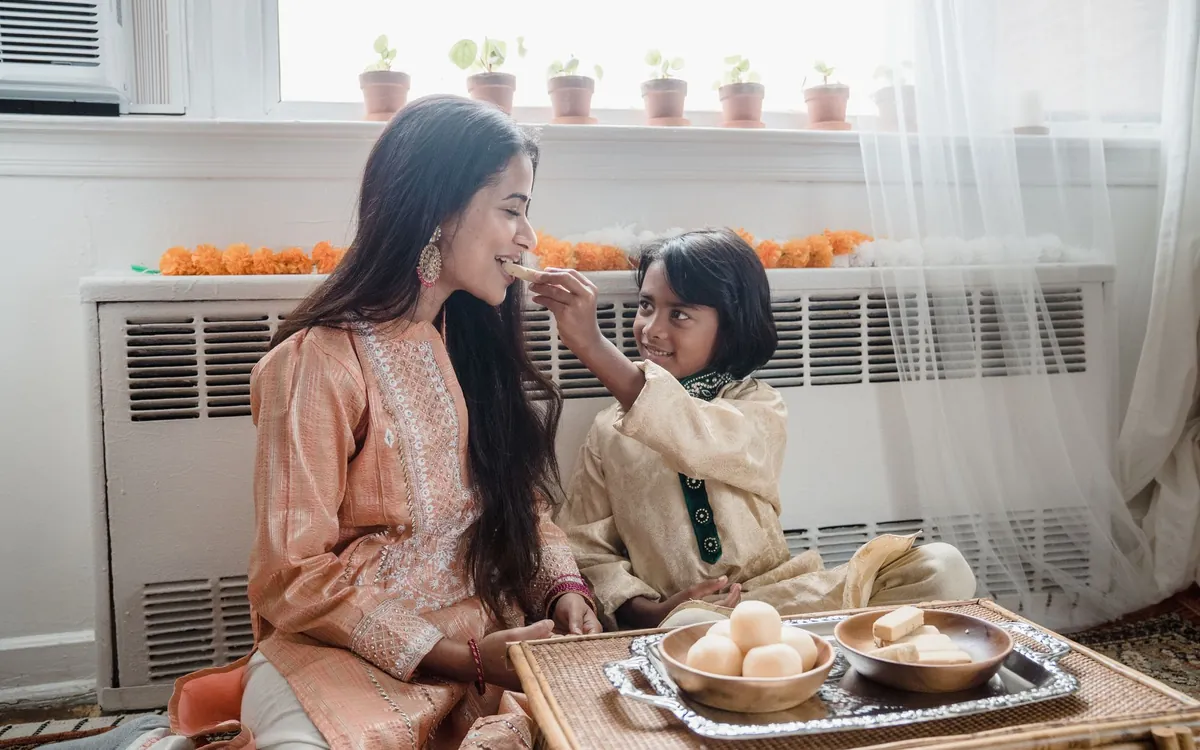 An Indian mother sharing a sweet moment with her son at home