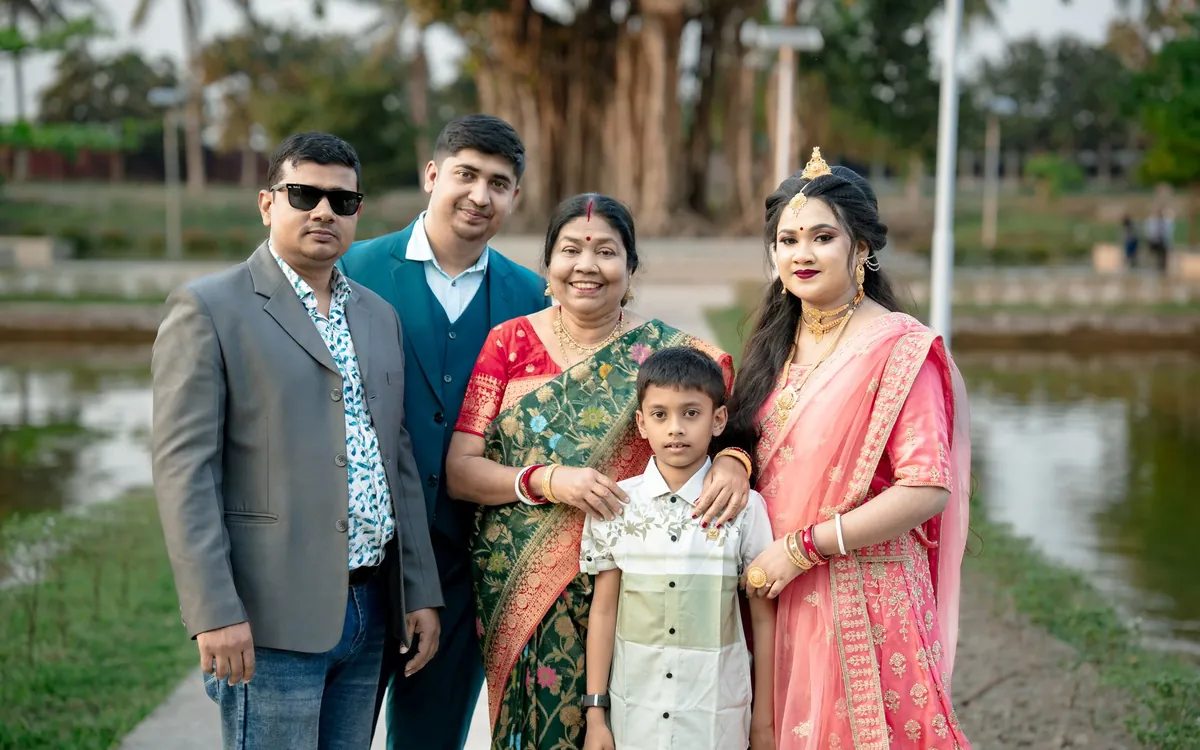 An Indian family posing together by a lake