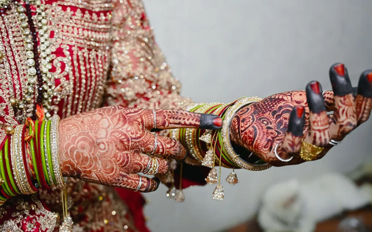 A bride's hands with mehndi, bangles and kaleeras
