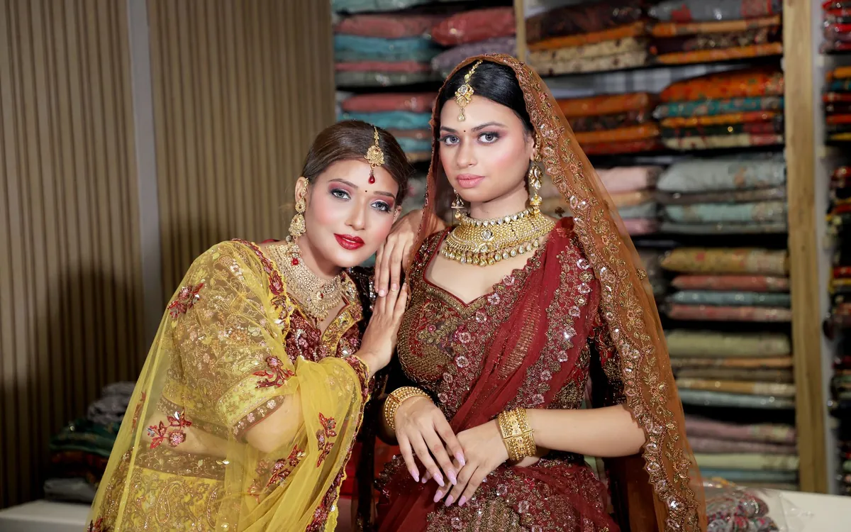 Two brides in lehengas in a saree shop