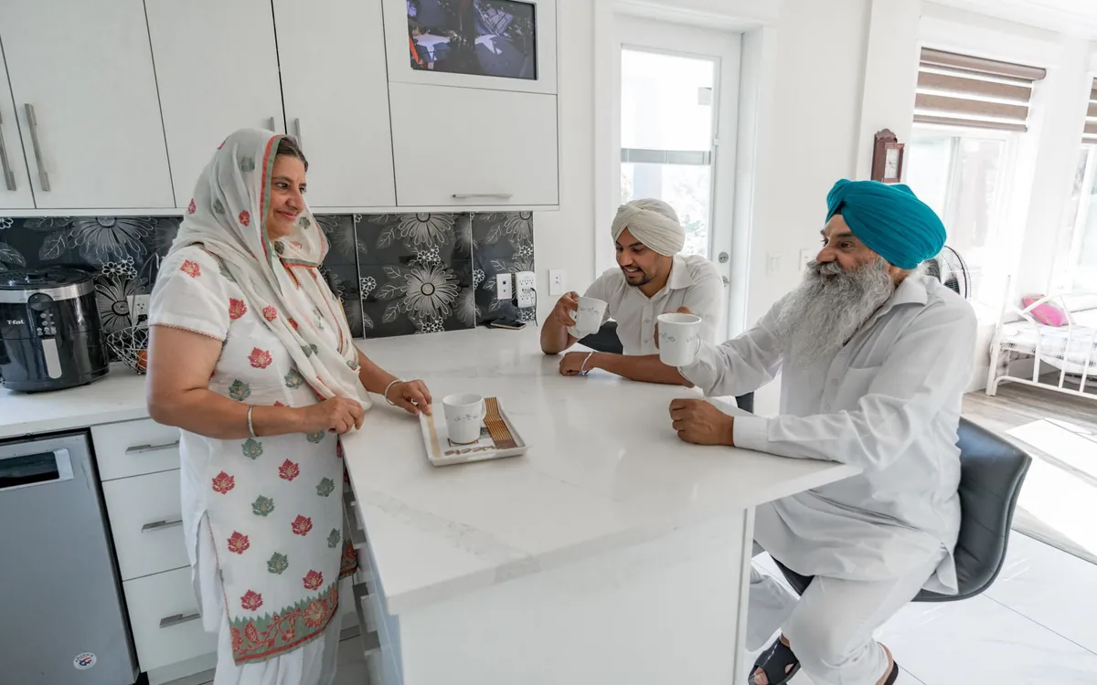 A Punjabi family chatting around a kitchen table