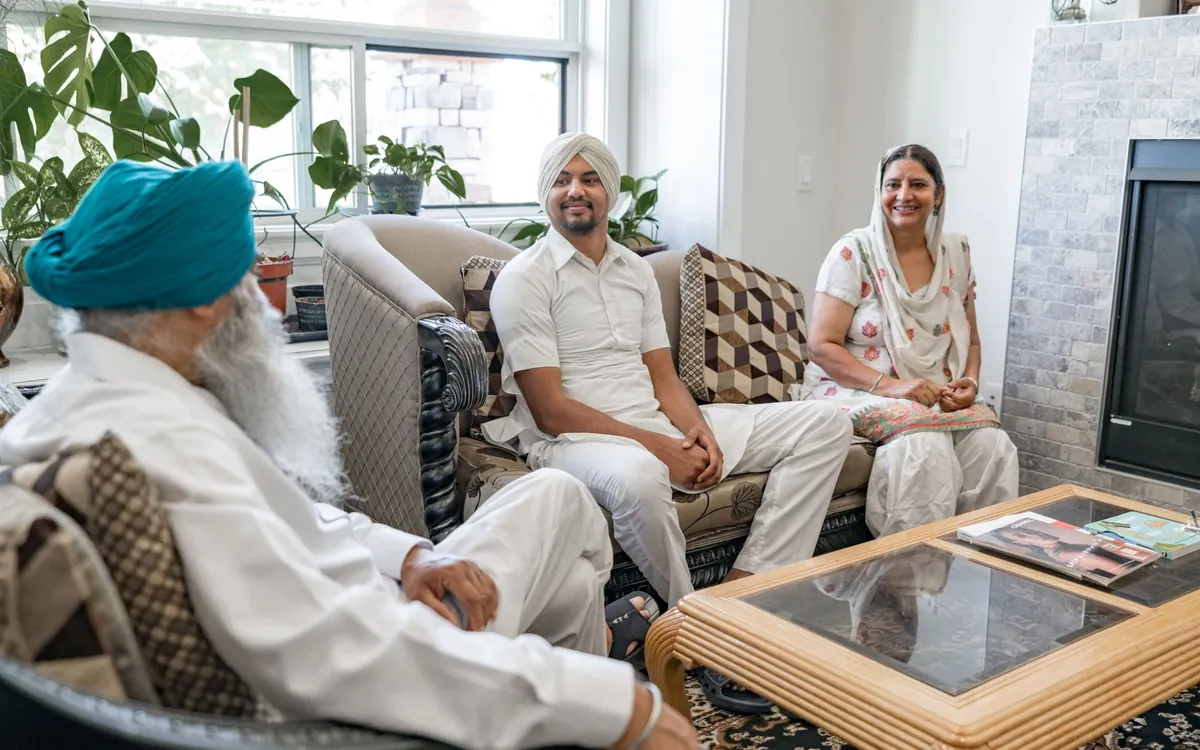 A Sikh family seated together in a bright living room