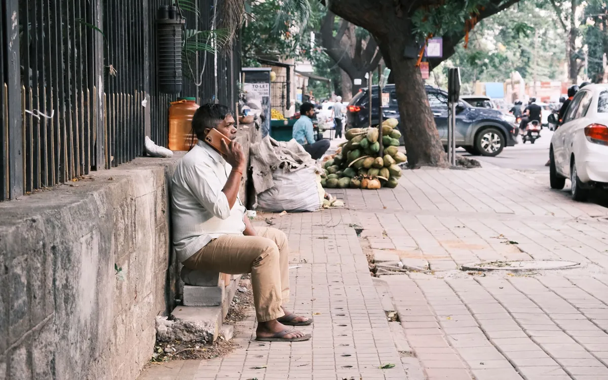 An Indian man speaking to a prospective match on the phone