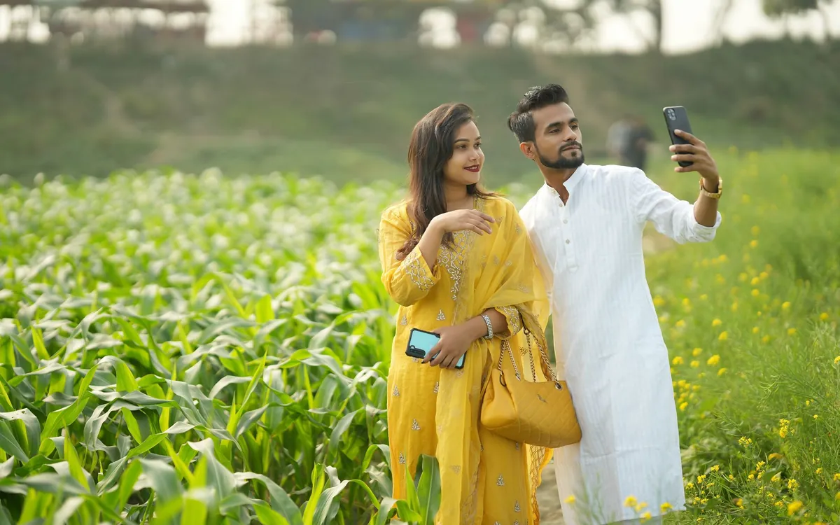 An Indian couple smiling as they take a selfie together after getting to know each other