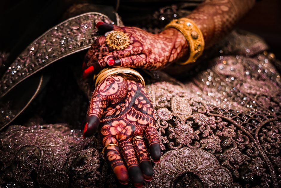 A bride's henna-adorned hands, part of the rituals that follow a gotra-approved match