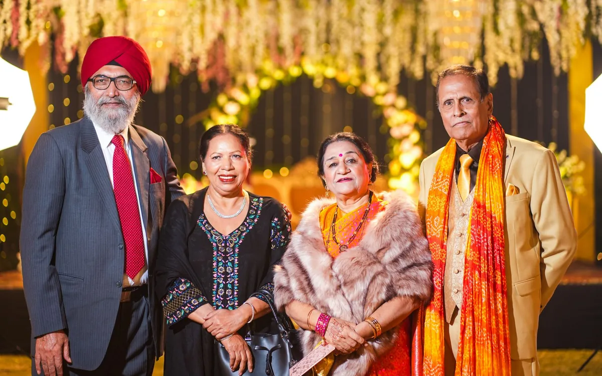 Elderly relatives in festive clothes posing at a wedding reception