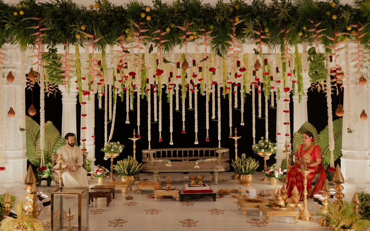 A wedding mandap decorated with hanging flowers