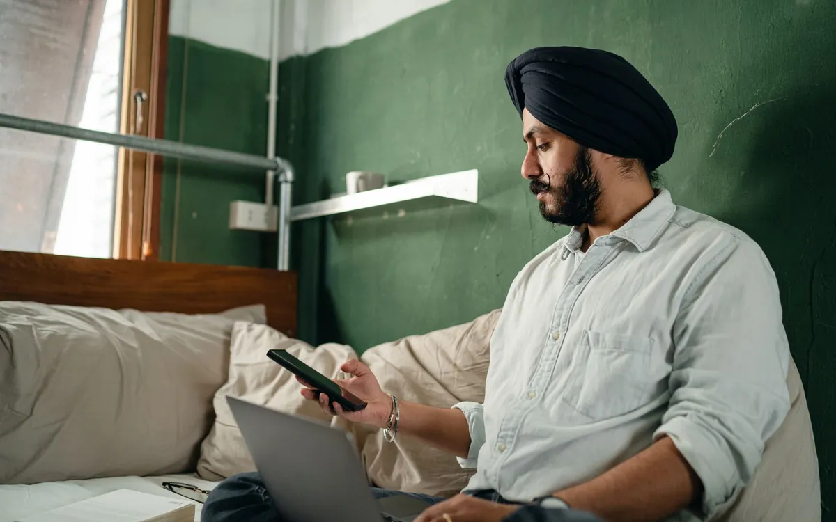 An Indian man going through shortlisted matrimony profiles on his phone