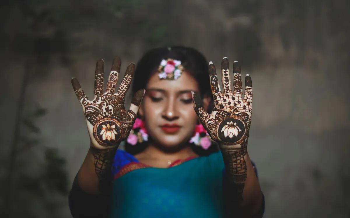 A young woman showing her hennaed palms