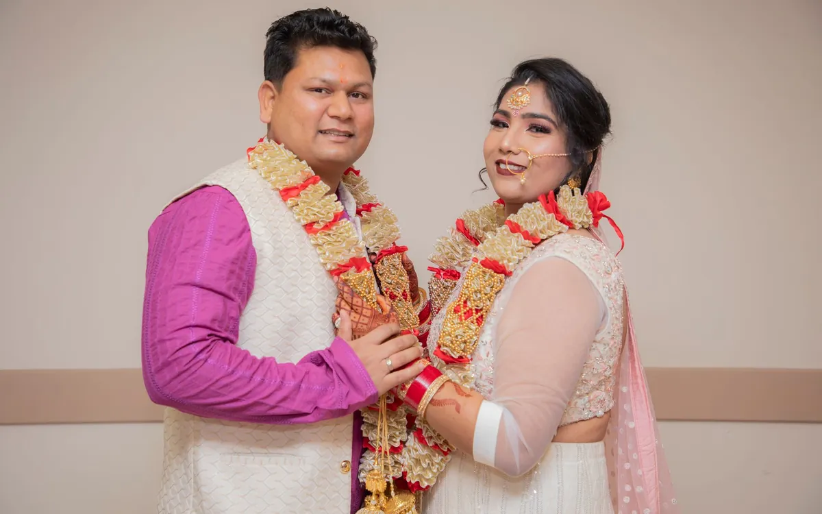 An Indian couple exchanging garlands at their wedding
