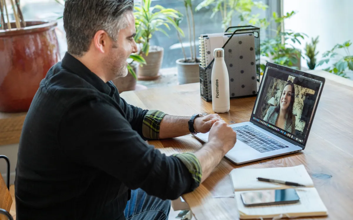 An Indian man on a video call on his laptop, a common first step in online matchmaking