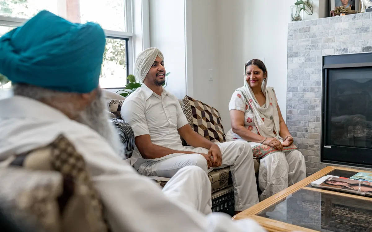 An Indian family sitting together at home discussing a marriage proposal