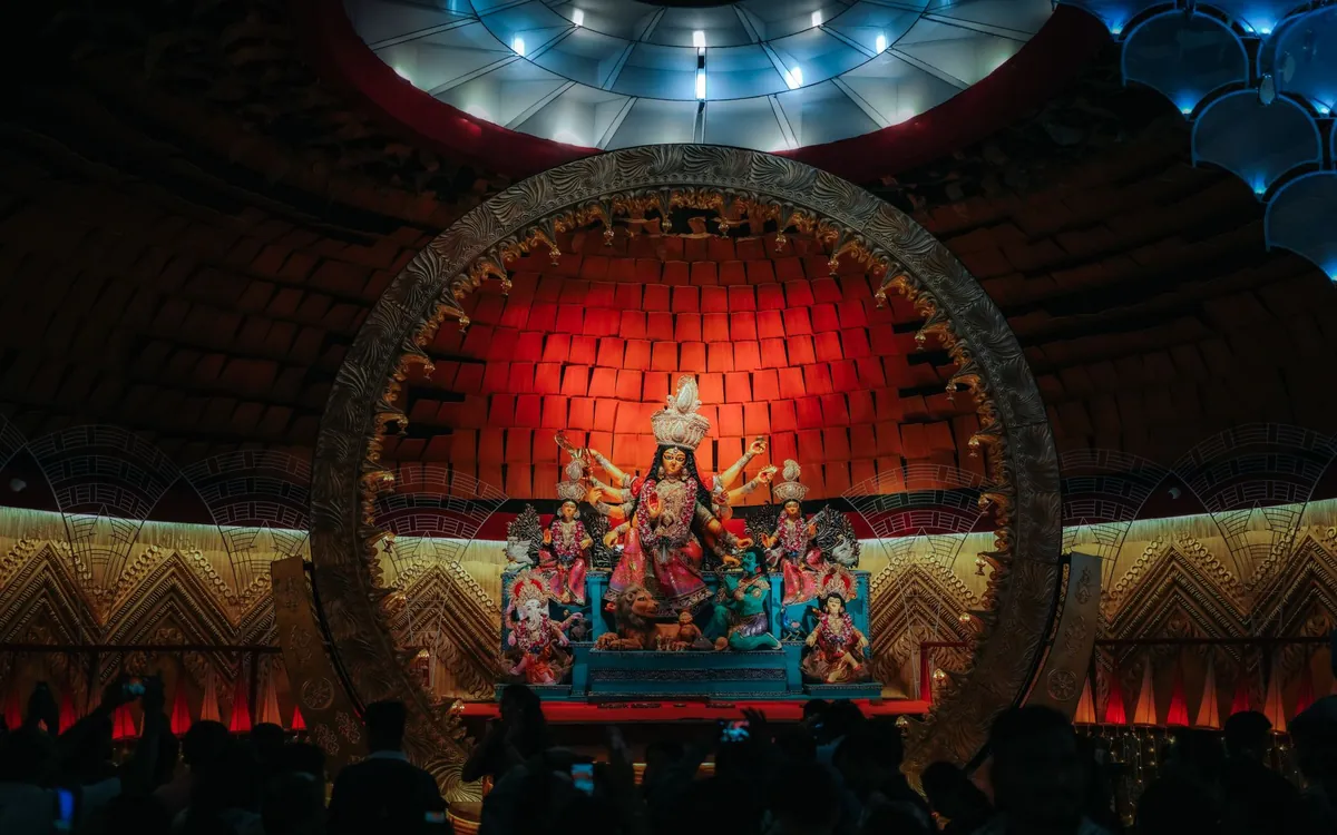 A Durga Puja pandal lit up with the goddess idol at its centre