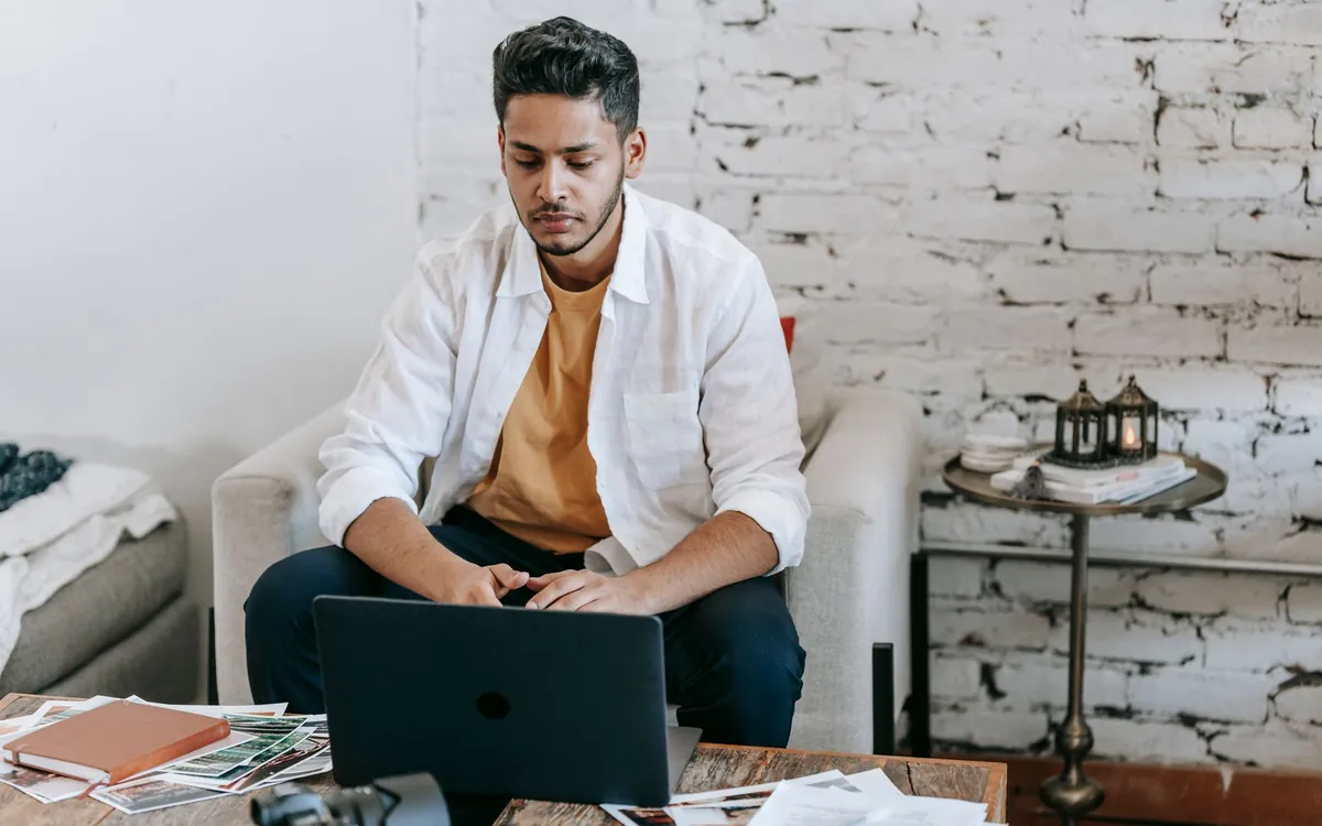 A young Indian man searching for a life partner on his laptop at home
