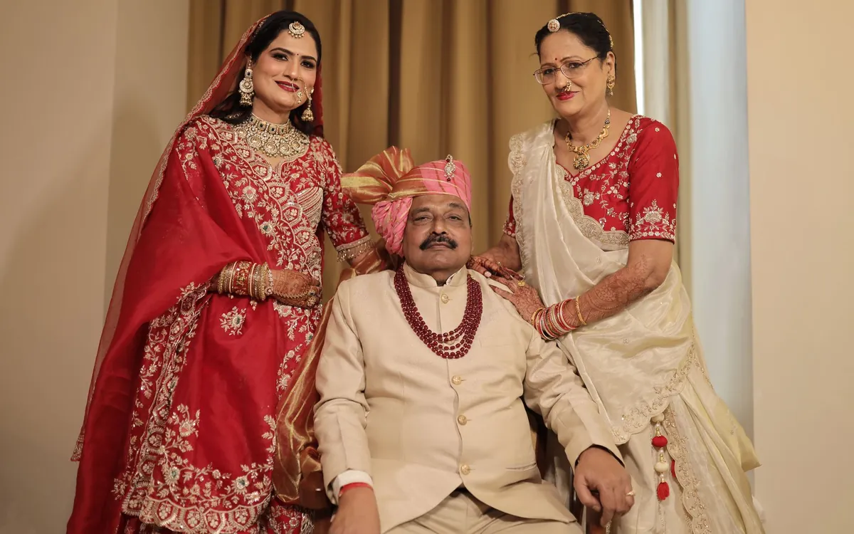A bride with her parents in traditional wedding clothes