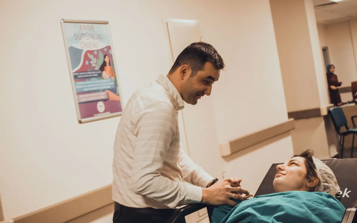 A doctor attending to a patient lying in a hospital bed