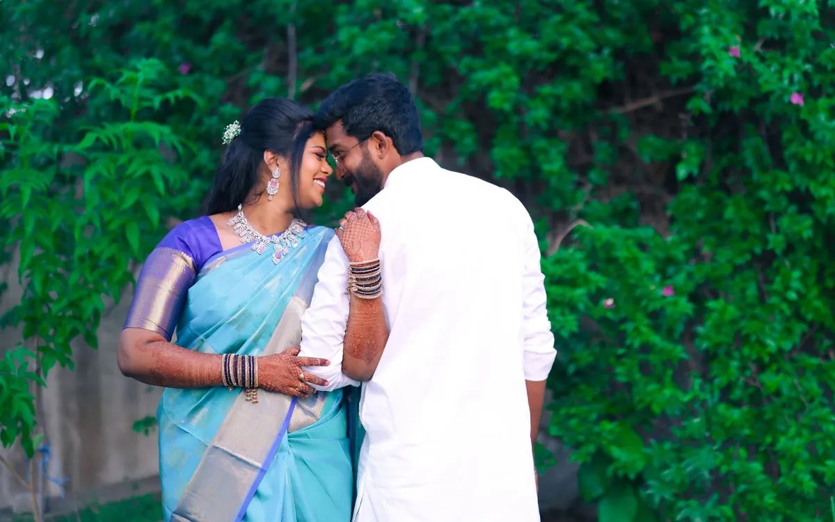 An Indian couple in traditional clothes sharing a quiet moment outdoors