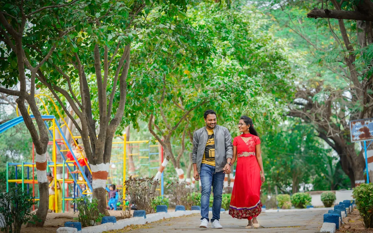 An Indian couple walking together along a garden path